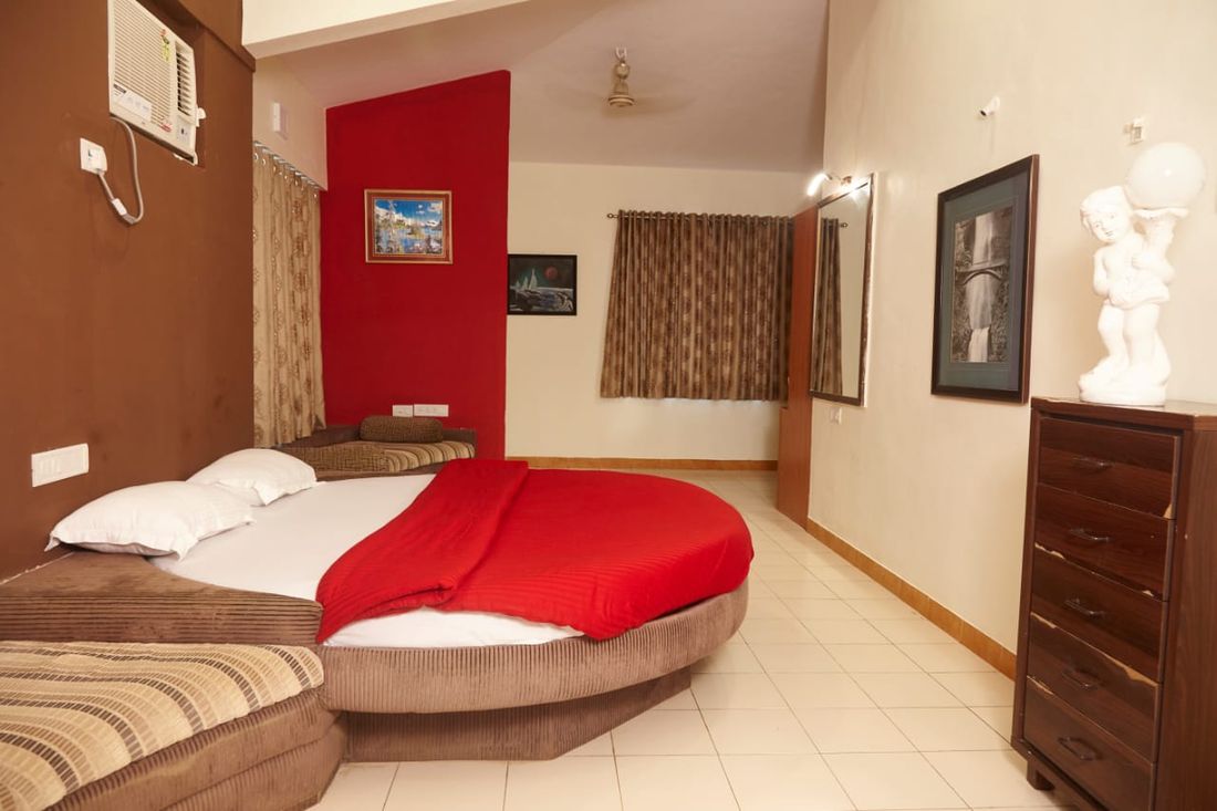 Bedroom with a round bed and seating