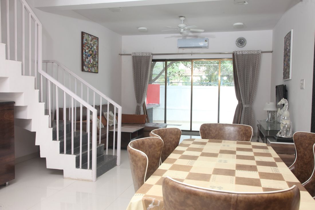 Living and dining area with the staircase behind